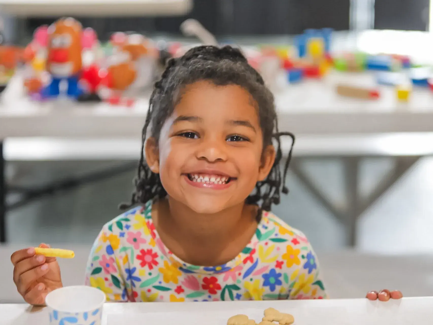 A child smiling at a Good News Co. gathering.