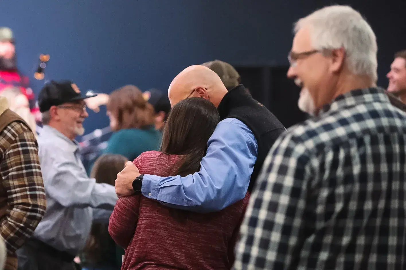 People embracing during a Good News Co. gathering.