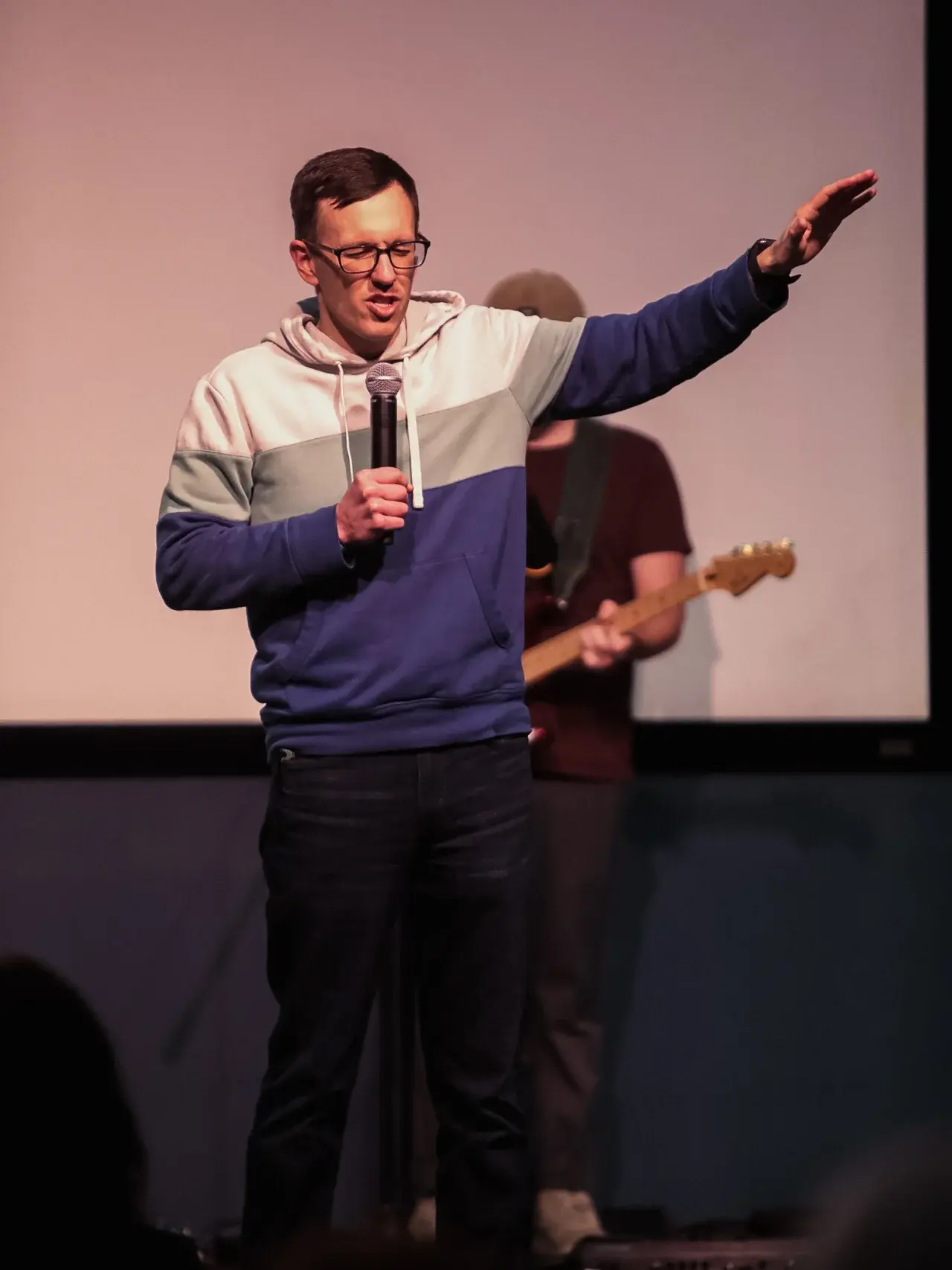 A Good News Co. leader praying during a gathering.