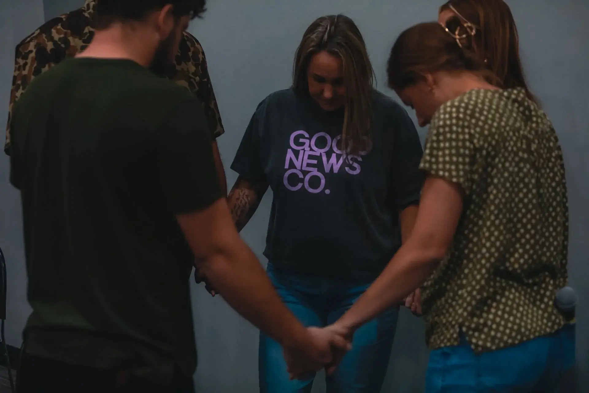 Good News Co. volunteers praying together.