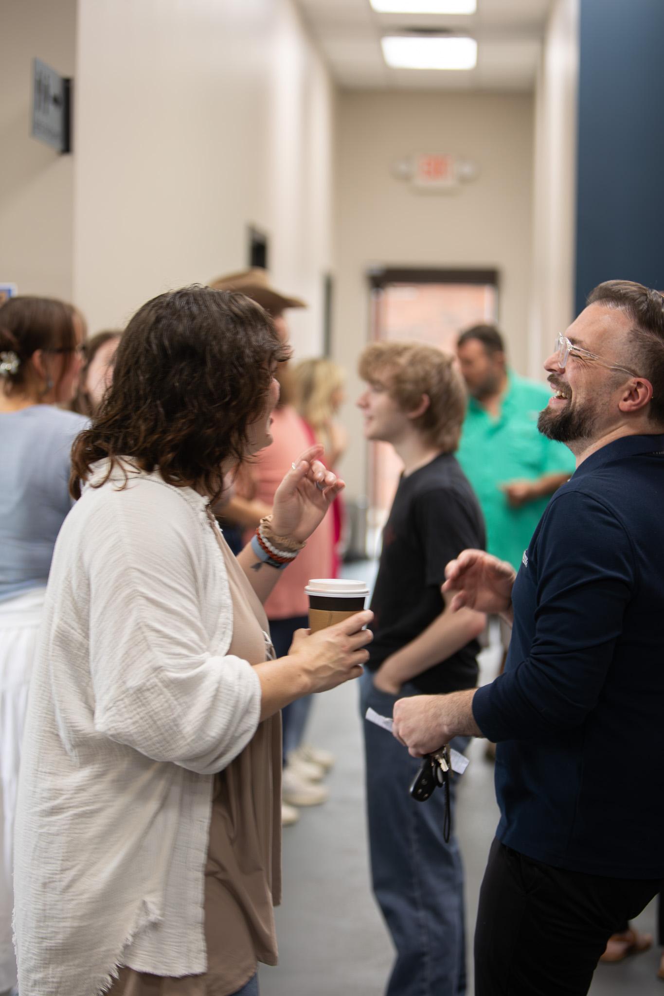 Friends sharing conversation at Good News Co.